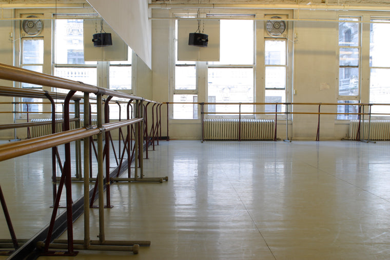 Interior view of one of Steps' dance studios, with mirrors, barre, and soaring windows